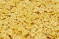 Dry uncooked farfalle pasta as a background. Flat lay Royalty Free Stock Photo