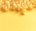 Dry uncooked italian pasta cavatappi on a yellow background with copy space