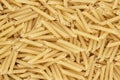 Dry uncooked penne lisce pasta texture background Royalty Free Stock Photo