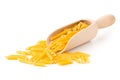 Dry, uncooked, raw penne pasta noodles in wooden scoop Royalty Free Stock Photo