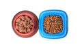 Dry and wet pet food in feeding bowls isolated on white, top view Royalty Free Stock Photo