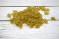 Dry wheat pasta on a wooden background