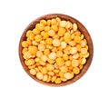 Dry yellow split peas in wooden bowl, isolated on white background. Halves of yellow legume peas. Top view.