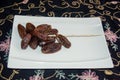 Dryed Dates. Dates on a white plate. Royalty Free Stock Photo