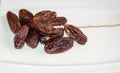 Dryed Dates. Dates on a white plate. Royalty Free Stock Photo