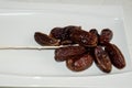 Dryed Dates on a white plate.