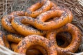 Dryers, bagels, golden baked and sweet round buns with poppies in the form of rings in wicker baskets made from a vine. Appetizing