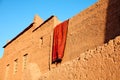 Drying carpet on the earthen walls of the house