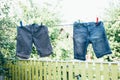 Drying clothes in garden, cotton shorts hanging in sunlight after washing, Laundry day Royalty Free Stock Photo