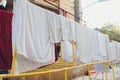 Drying clothes in the unusual sunset. White towels and sheets dry in the sun on stretched laundry ropes. Washing laundry Royalty Free Stock Photo