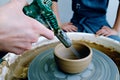 Drying finished ceramic bowl with industrial hot air gun. Ceramics workshop concept