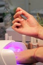 Drying and fixing a transparent base base applied to the nails before using shellac with an ultraviolet lamp Royalty Free Stock Photo