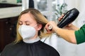 Drying hair with a hair dryer and a round brush, hairdressing procedures