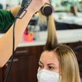 Drying hair with a hair dryer and a round brush, hairdressing procedures