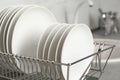 Drying rack with clean dishes on kitchen counter Royalty Free Stock Photo
