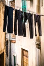 Drying trousers in a narrow street Royalty Free Stock Photo