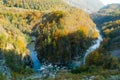 Drying up blue river flows deep in the canyon against the autumn forest. Royalty Free Stock Photo