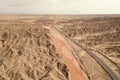 Dryness land with erosion terrain with highway crossing Royalty Free Stock Photo