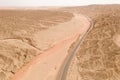 Dryness land with erosion terrain with highway crossing Royalty Free Stock Photo