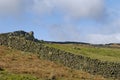 Drystone Walls leading up to small Crags of Gritstone on Burley and Ilkley Moors in West Yorkshire Royalty Free Stock Photo