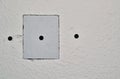 Drywall repairs in wall with a square repair panel inserted.