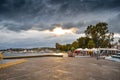 View of tthe harbor and beach in Megalo Pefko Nea Peramos under a dramatic sky at sunset,Attica,Greece