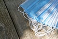 Blue face masks on a wooden table Royalty Free Stock Photo