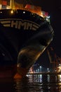Night shot of a container ship with freight cranes in the background