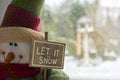 Snowman doll with Let it snow sign Royalty Free Stock Photo