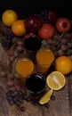 Fresh Fruits and four glass of juice in wooden table Royalty Free Stock Photo