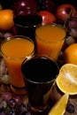 Fresh Fruits and four glass of juice in wooden table Royalty Free Stock Photo