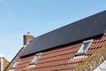 A row of dark solar panels on a house roof Royalty Free Stock Photo