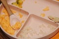 Messy baby plate with scrambled eggs, rice, saltine cockie and avocado remnants Royalty Free Stock Photo