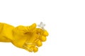 Hand in yellow glove holding clear liquid bottle on isolated white background. Close-up view of transparent bottles Royalty Free Stock Photo