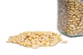 Shelled peanuts spilling from glass jar on isolated white background Royalty Free Stock Photo