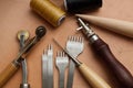 Leather Crafting Tools on the Genuine Leather on the Table, Handicraftsman Equipment for DIY Leather Works