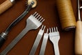 Leather Crafting Tools on the Genuine Leather on the Table, Handicraftsman Equipment for DIY Leather Works