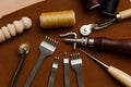 Leather Crafting Tools on the Genuine Leather on the Table, Handicraftsman Equipment for DIY Leather Works