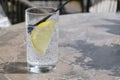 A glass of cold sparkling soda with a slice of yellow lemon Royalty Free Stock Photo