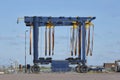 Large empty mobile boat travel lift in a harbour under a blue sky