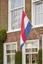 Dutch flags waving in a dutch street on Koningsdag Royalty Free Stock Photo