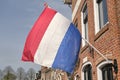Dutch flags waving in a dutch street on Koningsdag Royalty Free Stock Photo