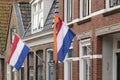 Dutch flags waving in a dutch street on Koningsdag Royalty Free Stock Photo