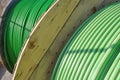 Wooden rolls of green colored industrial tube cable Royalty Free Stock Photo