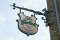 Grolsch logo on an antique-looking sign in a street