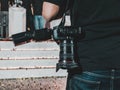 DSLR camera carried by a camera man part of media crew at an live Esports event with confetti on the ground. Royalty Free Stock Photo