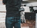 DSLR camera carried by a camera man part of media crew at an live Esports event with confetti on the ground. Royalty Free Stock Photo