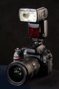 DSLR camera, lens and flash on black Royalty Free Stock Photo