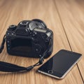 A DSLR camera and a smartphone Royalty Free Stock Photo