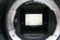 dslr digital camera without body cap showing the mirror and camera sensor, defocused open old dslr digital camera Royalty Free Stock Photo